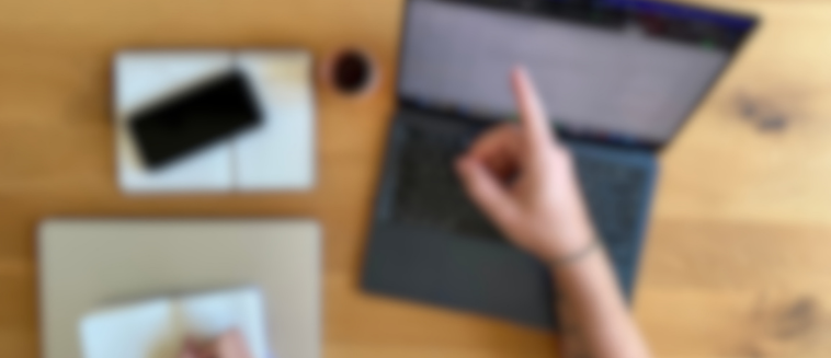 Blurry Bild mit Finger der auf Laptop zeigt